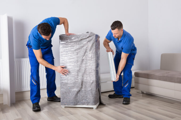 Two Male Movers Packing Furniture