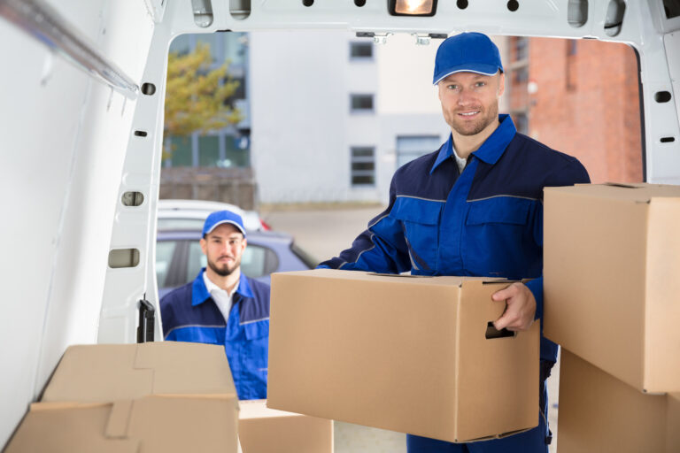 Mover Unloading Cardboard Box From Truck