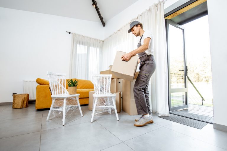 Professional mover delivering furniture to a new house